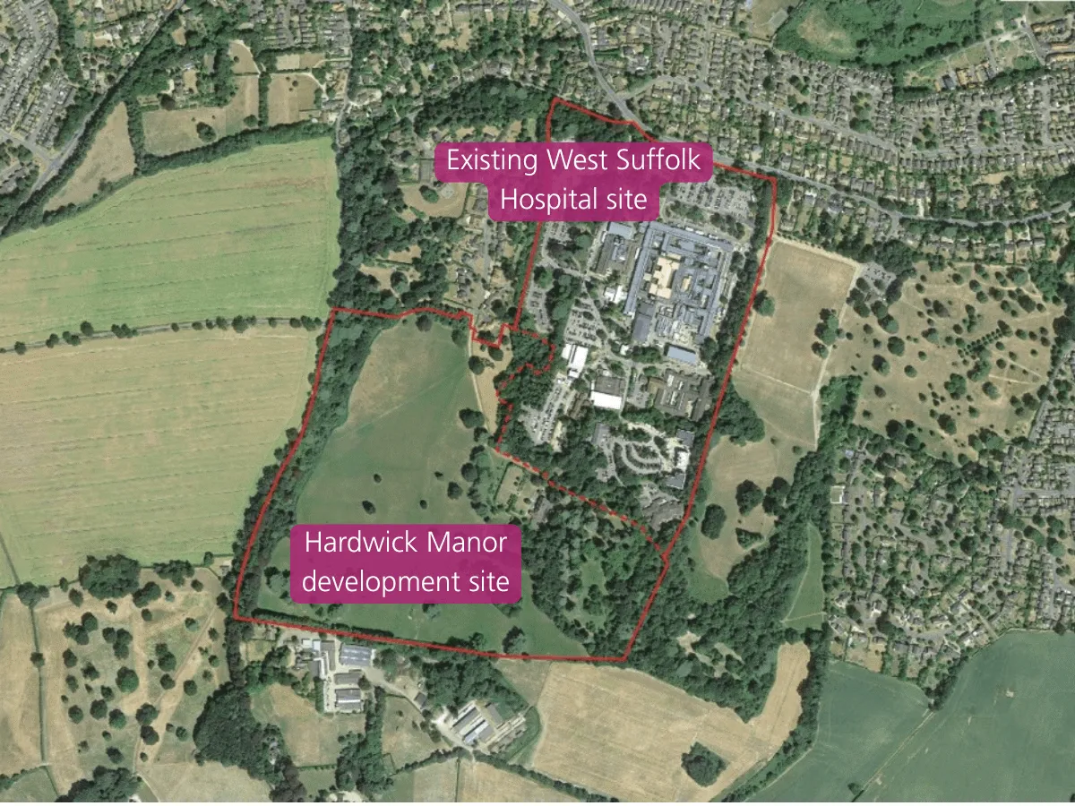 Aerial satellite image of the West Suffolk Hospital site outlined in red, showing the existing hospital buildings, surrounding parkland and tree cover, adjacent residential areas to the north and east, and open farmland to the west and south.